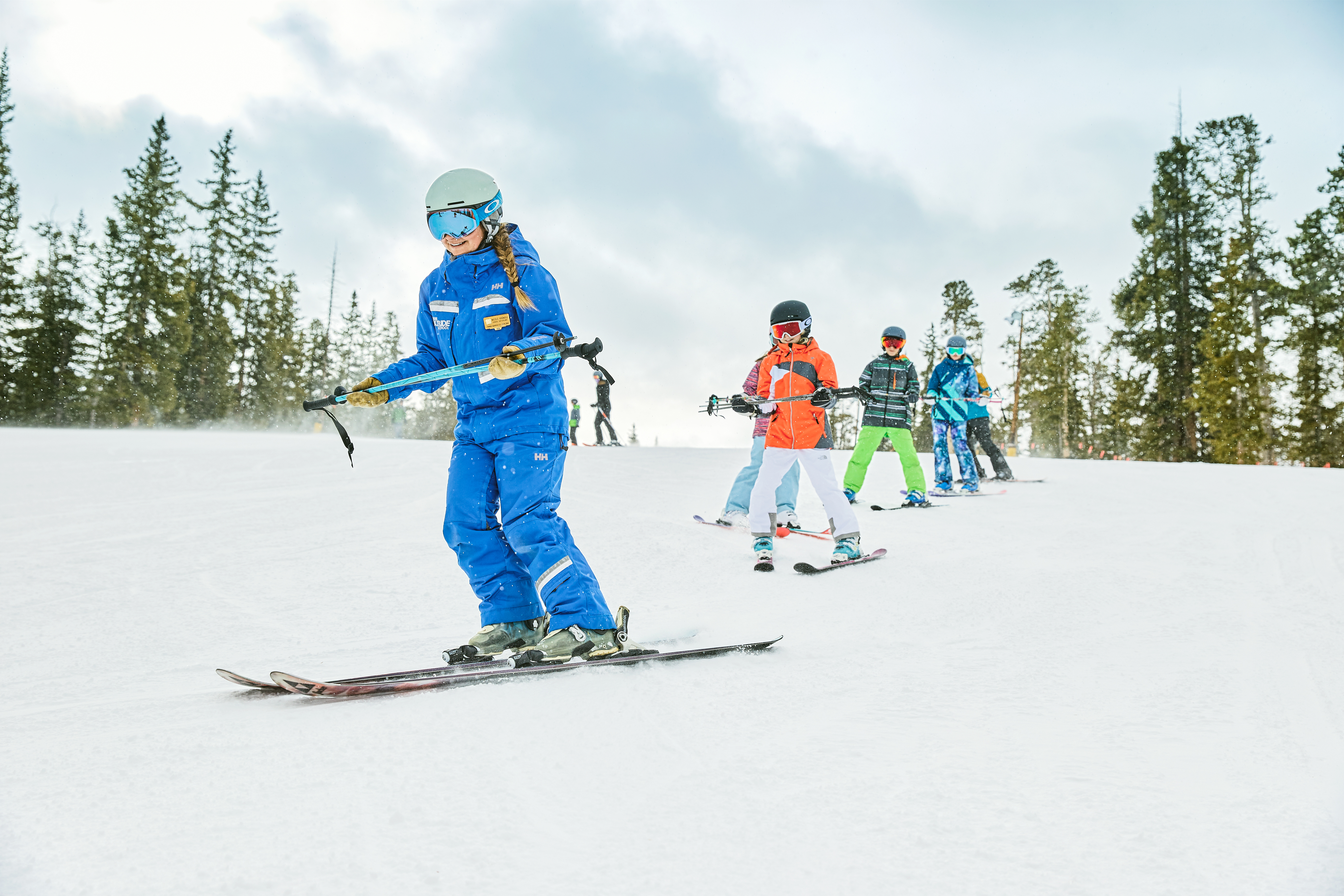Instructor leading a group of children in a ski lesson at Keystone Resort